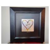 Limited edition, rainbow-colored heart created through book folding, by Jeff Johnson, numbered 119/250. 15 1/4" x 15 1/4", wide black leatherette frame. Changes as you walk by.