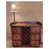 Pottery Barn Wine Cabinet, railing around 3/4 of the top, 2 upper drawers, 2 lower compartments,  wine rack in the middle, wooden feet, 38 1/4" T x 42 1/4" W x 20" D. Bottom right compartment door has