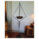 Wrought iron bird feeder featuring a suspended copper dish, in the Arts and Crafts style. 56" T, 20" W, 13" Deep