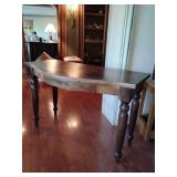 Colonial-style table, solid oak, prominent lathe-turned legs with a bobbin or spindle design, which is a classic detail of Victorian and farmhouse furniture, and a live-edge or slightly curved distres