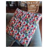 Geometric throw pillow features a multicolored Harlequin triangle tapestry pattern, similar to Turkish Kilim designs. 
Multicolored geometric triangles.
 Contemporary take on traditional tapestry or K
