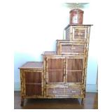 Asian-style bamboo staircase display cabinet featuring multiple drawers and doors for storage. 34" T x 27 1/2" W.