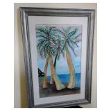 Signed watercolor painting of tropical palm trees overlooking the ocean, framed in a metallic look frame. 15 1/4" x 22 1/2".