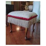 Vintage-style footstool wooden cabriole legs an upholstered seat adorned with a rooster motif and red trim and ivory fringe. 19" T x 19" x 19".