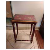 Asian chinoiserie style red lacquered wood side table with hand-painted gold accents. 21" T x 16" W x 12" D.
