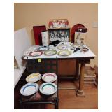A collection of dinnerware and decorative items primarily features the Williams Sonoma "Les Garçons" (Waiters) pattern by Guy Buffet. 
 The set includes multiple plates, a pasta canister, and a platt