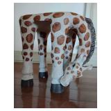 Giraffe-shaped plant stand is crafted from durable, hand-painted resin and can also function as a decorative foot stool. 11" T x 11" W.