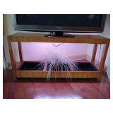 Indoor plant grow light system designed to provide artificial sunlight for houseplants. Wooden console table/planter box designed to hold plants. 24 1/4" T x 50" L x 14" Deep. Grow light in top, 3 pla