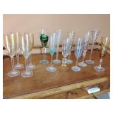 4 Vintage champagne flutes, amber tint on the bowl and a clear stem and base, and 9 mixed champagne flutes.