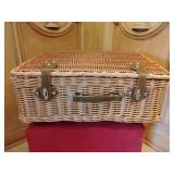 Wicker picnic basket featuring a traditional woven design with a leather handle and closures.  8" thick or T x 19" x 15". One bottom/back corner is damaged see pic.