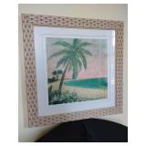 Tropical beach scene with palm trees, wicker style frame. 19" x 19".