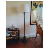 The Threshold 62.5"x16" Londonberry Stick Floor Lamp in black features a slender metal body with a turned base and a white linen drum shade, providing a stylish and functional lighting option. It incl