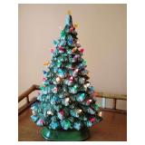 Slim Oval Ceramic Lighted Christmas Tree Windowsill Centerpiece, plug-in, works, few broken builds, has couple of loose ones to reglue.
16" T x 10 1/2" W x 5" Thick.