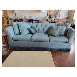 Vintage-style sofa features button tufting and a distinct bullion fringe trim along the bottom, soft medium blue, 93" W x 39" D x back height 33 1/2", with several throw pillows.