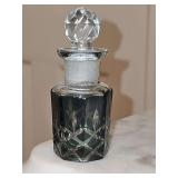 Vintage green glass perfume bottle with faceted clear glass stopper. 3.5 in tall.