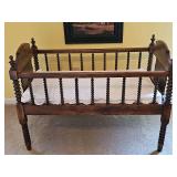 Antique walnut spool baby bed/cradle. c.1865 38.25x20.75x28.5 in tall at ends. Bed height is 15.5in tall. Rail height is 24.5 in.