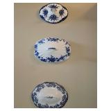 Trio of antique domed porcelain lids used as decor pieces.