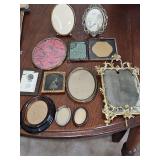 Antique and vintage photo frames. Tin, copper, brass, wood. Red swirl background has curved glass.