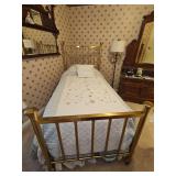 Vintage twin brass bed on casters as shown. Solidly made. Headboard is 56.5 in tall. Foot board is 36 in tall.