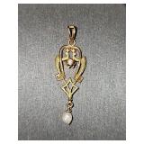 10K yellow gold pendant with small clear stone. 1.25 in tall.
