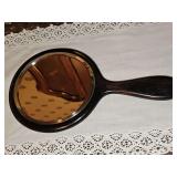 Handheld mirror in genuine ebony. 5.5 in wide x 10 in long.