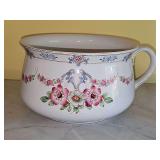 Vintage chamber pot with floral motif. 10.5x5.5in tall.