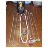 Grouping of costume jewelry. Necklaces, pearl look strand, antique earrings, bracelet and breast cancer pin. Amber necklace is set in sterling, flag pin is sterling. See all photos.