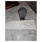 Vintage leather gloves with an antique Art Deco fan-shaped hair comb used as a displace stand. Very unique.