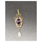 10K yellow gold pendant with pruple stone. 1.25 in tall.