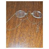 Unique antique rimless glasses by Stevens. Known as "nose pinchers," featuring a spring-loaded bridge that grips the nose instead of using ear arms. Gold color. No other markings found.