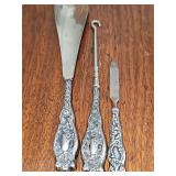 Antique sterling handle (per seller) dresser implements.