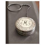 Antique sterling silver rouge or powder container with chain. Monogrammed "H" 1 in diameter.