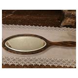 Antique beveled mirror in wood frame. 5 in at widest point at 17 in long. Silvering consistent with age.
