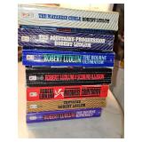 Grouping of 7 Robert Ludlum paperback books. See all photos.