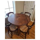 Antique table with 4 cane bottom chairs. Table is 37.5x 30.5 in tall. Chairs are 17x 17x 33 in tall. Seat height is 17.5 in.