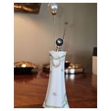 Antique hat pin holder with three pins. Holder is 5 in tall.