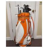 Orange and white golf bag and clubs - bag is in used condition and personalized on front - clubs are sizes 3, 4, 6, 8, 9 and makers are TrueTemper DynaLite, LPGA Light & Easy and Wilson Sandy-Andy - g