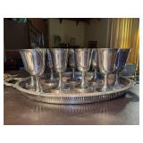 Silverplate serving tray with (9) goblets - a few have been spot-polished to show they’re brilliance but all need a good polishing