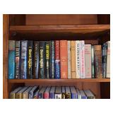 Shelf of books featuring various titles and authors