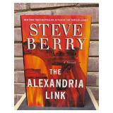 Signed first edition hardback copy of “The Alexandria Link” by Steve Berry…..includes dust jacket…..there is other info on opening page that has been darkened with sharpie…..see pics