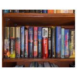 Shelf of hardback novels by Joel Rosenberg - all have dust jackets
