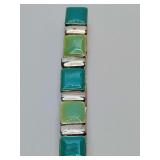 Vintage green colors enameled silver tone metal stretch bracelet. Pictures show wear on silver portions, almost unnoticeable when on wrist.