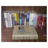 Shelf of books. Mostly hardback with dust covers.