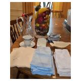 Miscellaneous grouping. Lenox Dove Bowl, blue and white covered bowl with duck lid, embroidered napkins, large vase with artificial florals.