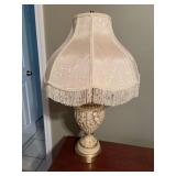 A  ceramic cherub and brass table lamp with fringe shade 7 1/2” x 30” the shade is 18 inches wide