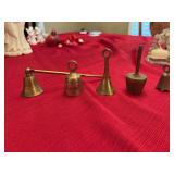 Four brass miniature bells with a candle snuffer