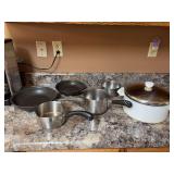 Two Kirkland skillets, two Revere wear pots and a fabric pot along with a Revere ware white Dutch oven