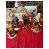 Group of four resin Santas one chip on hat