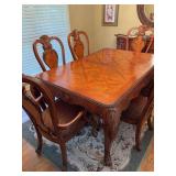 Beautiful Kathy Ireland Dining table with one leaf and six chairs, two of those being arm chairs. 48” x 72” x 30” with an additional 20 inch leaf. The chairs measure 23“ x 25“ x 46“. The s