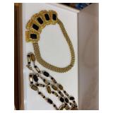Two black and gold necklaces